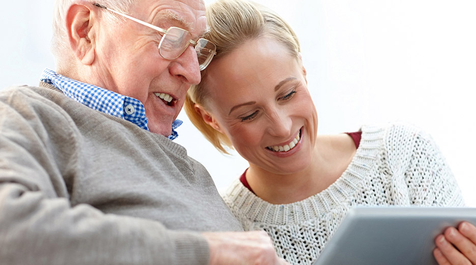 man and daughter looking at iPad